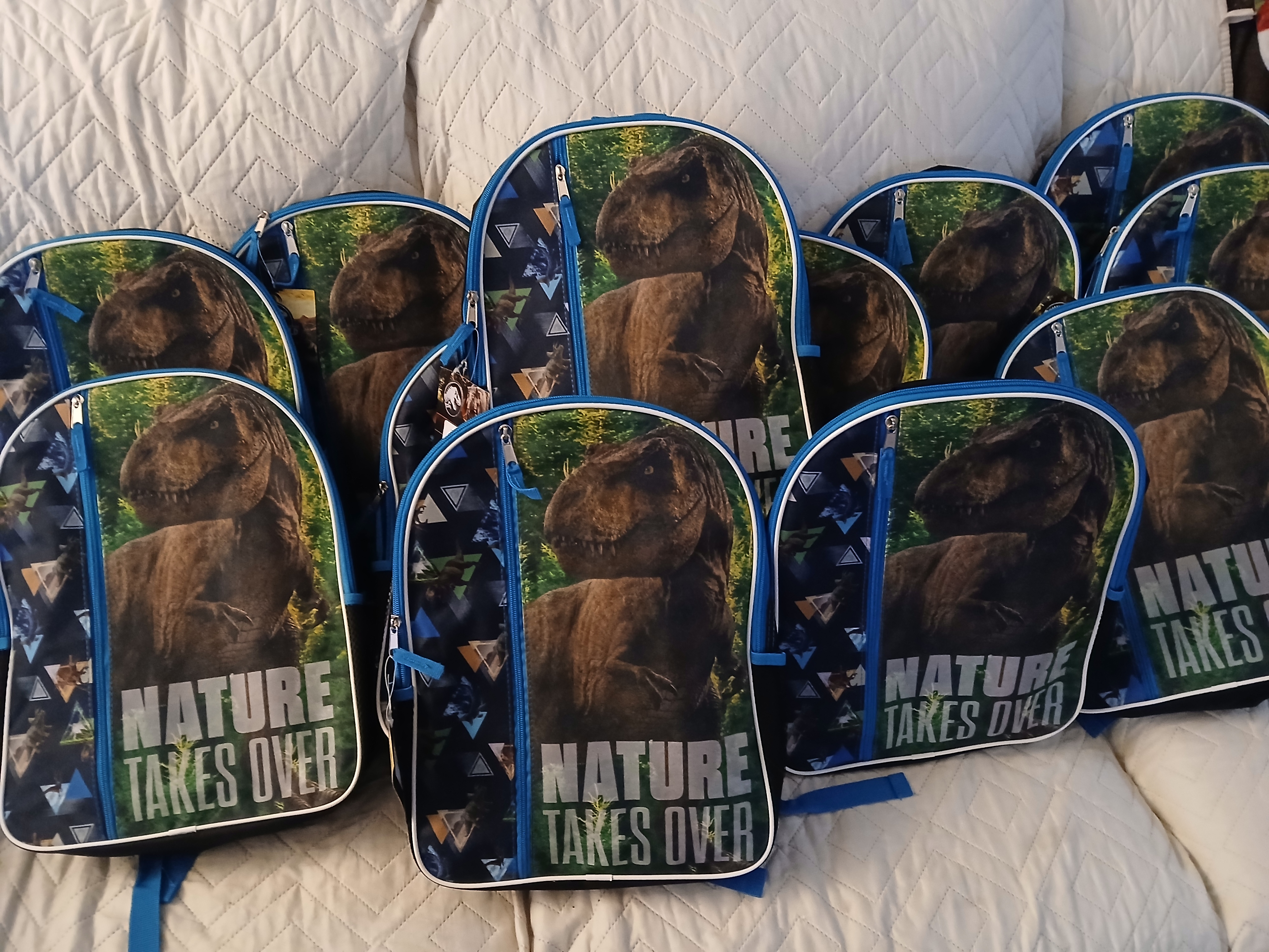 Dinosaur backpacks ready to become People's Packs for community distribution